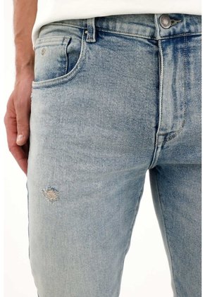 Tennis Jean Nudy Con Desgastes Localizados Azul De Ajuste Relajado Para Hombre Con Detalle único